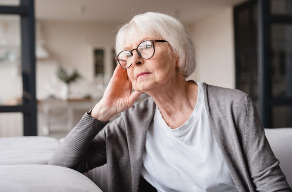 A senior holding pills tries to remember if they took their medication already.