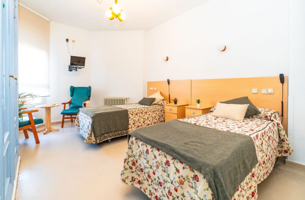 A bedroom with two separate beds in the same room.